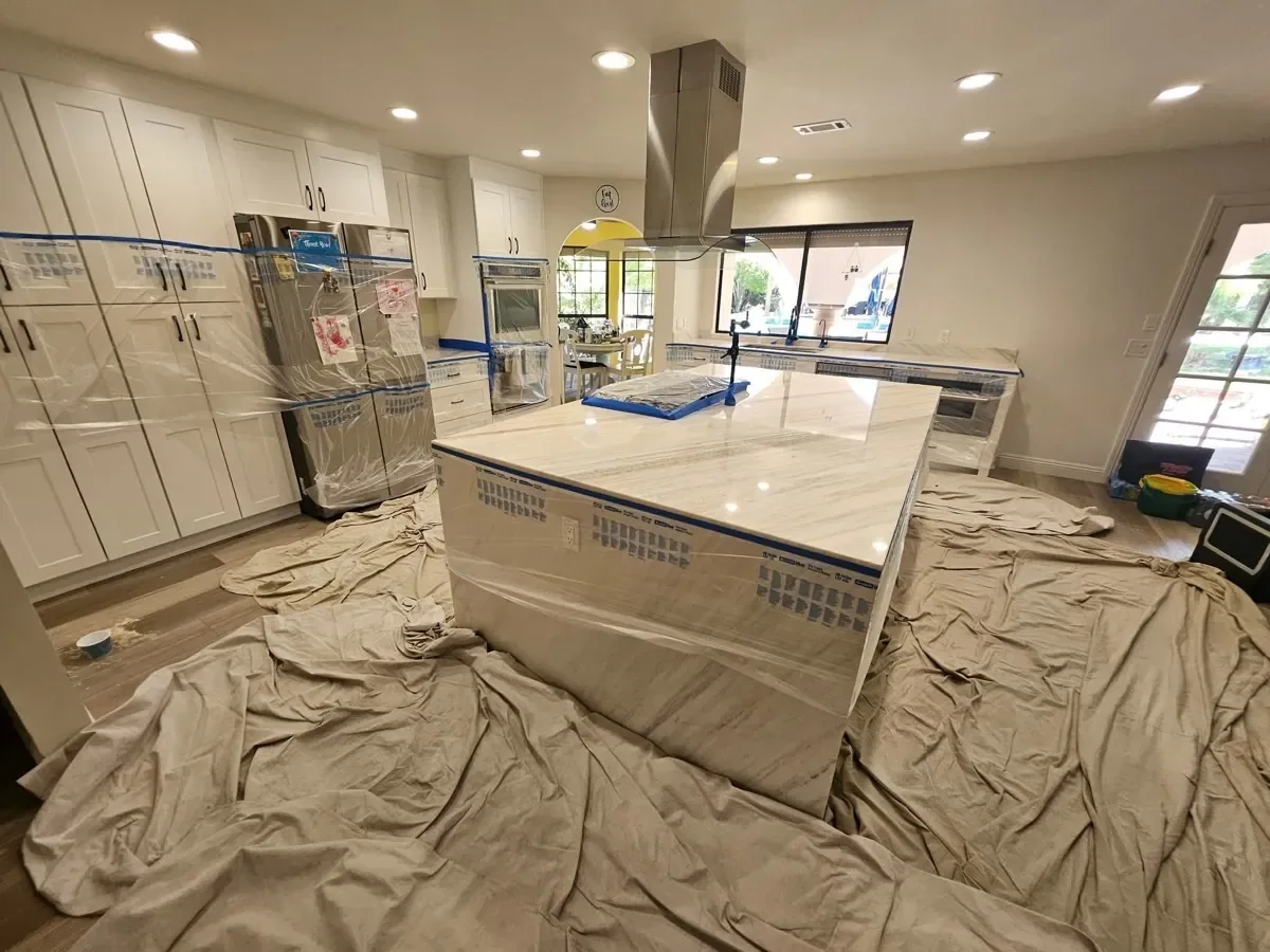 Protected stone kitchen island during professional countertop polishing